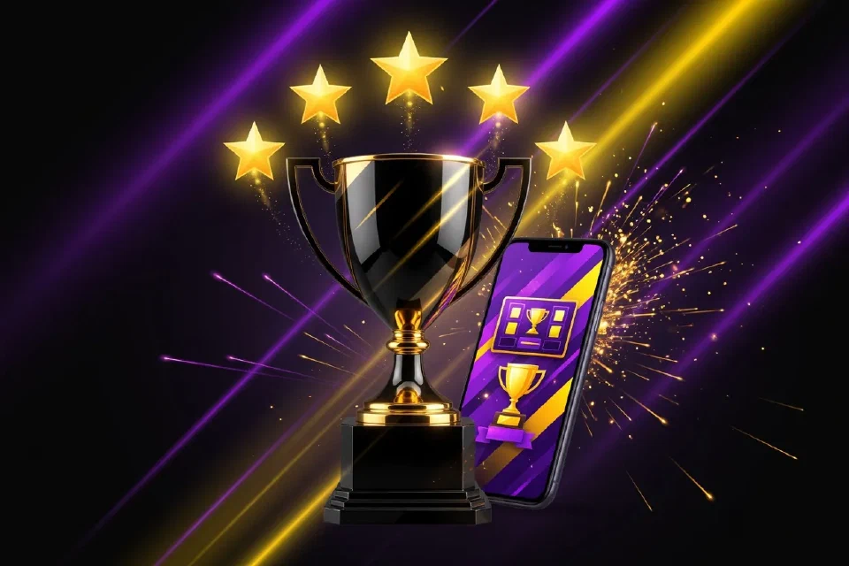 Cinco estrellas doradas sobre un trofeo junto a un teléfono